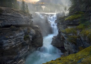 The cool waters of the Athabasca river in Jasper, Alberta on a misty morning.